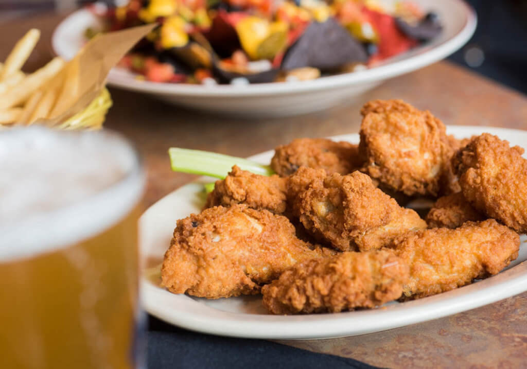 Chicken wings, nachos, fries, and beer