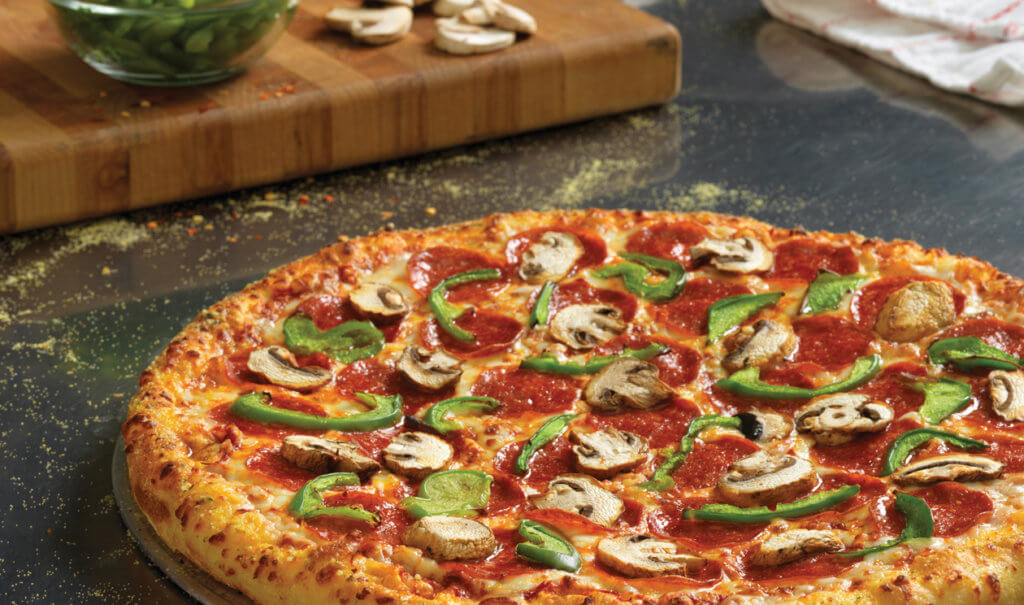 Pizza topped with pepperoni, green peppers, and mushrooms