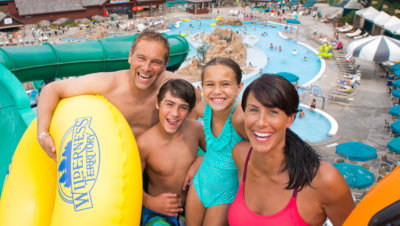 Family of four posing before going down a waterslide