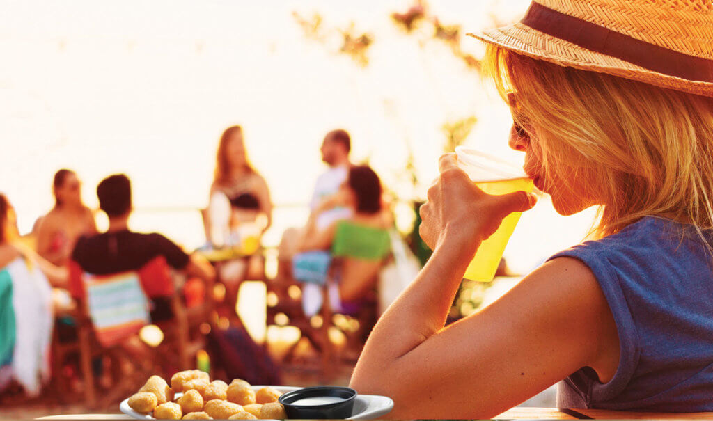 Crowd enjoying appetizers and drinks while dining outdoors