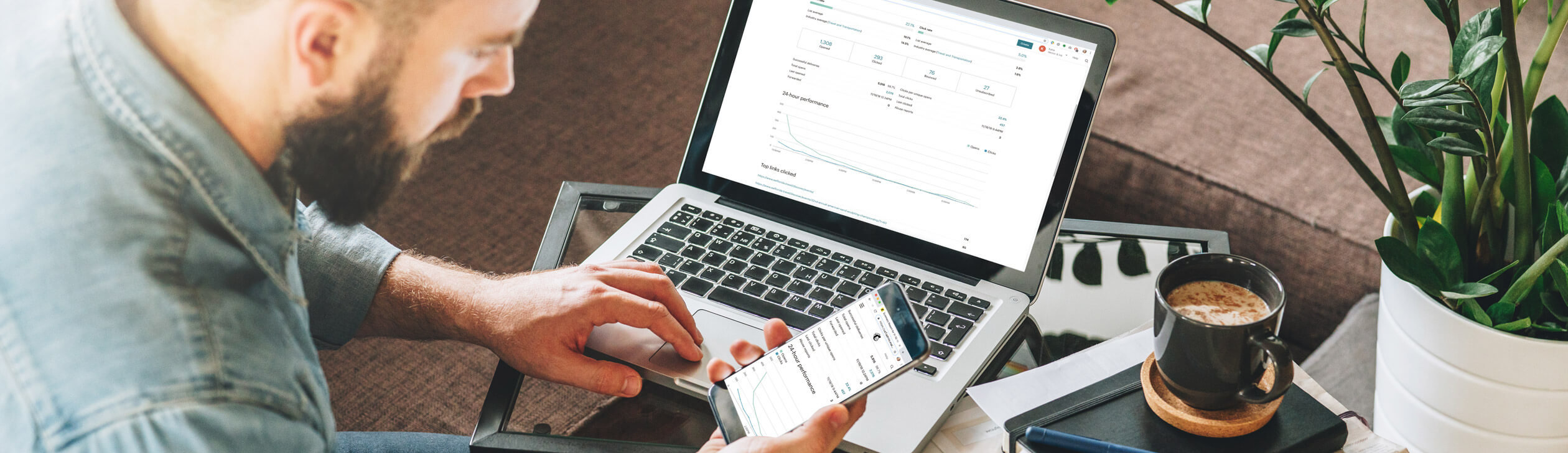 Man checking email on computer and mobile phone