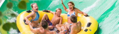 Family enjoying a large inner tube water slide